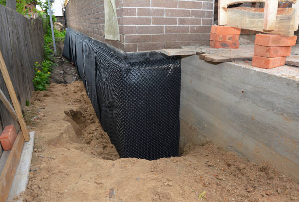 Happy homeowners after waterproofing job in Satsuma